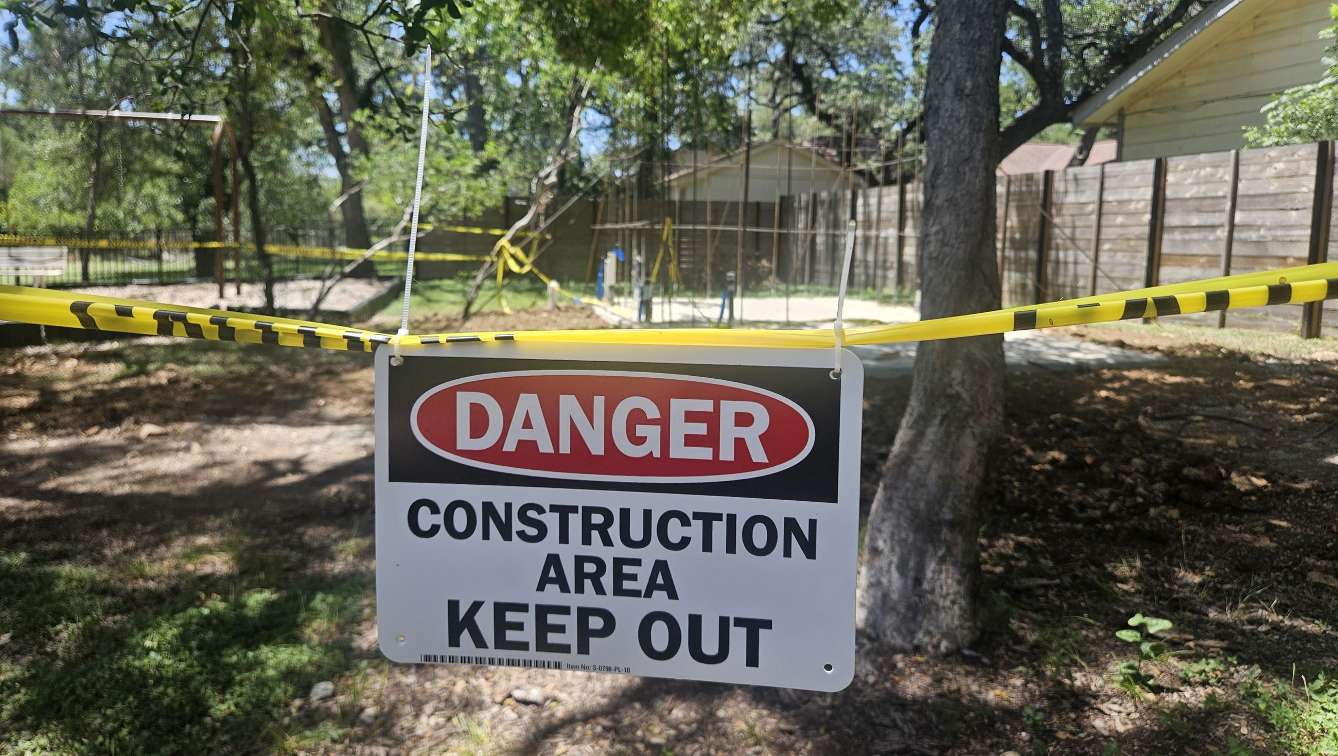Creekside Park construction sign with new bathroom foundation in background.
